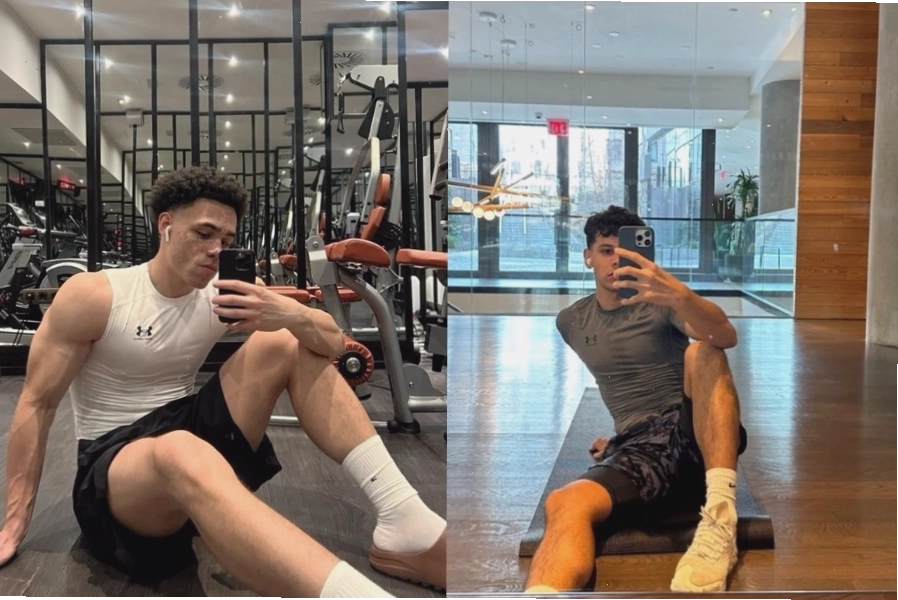 Chàng trai ngồi trên sàn phòng gym tạo dáng chụp ảnh