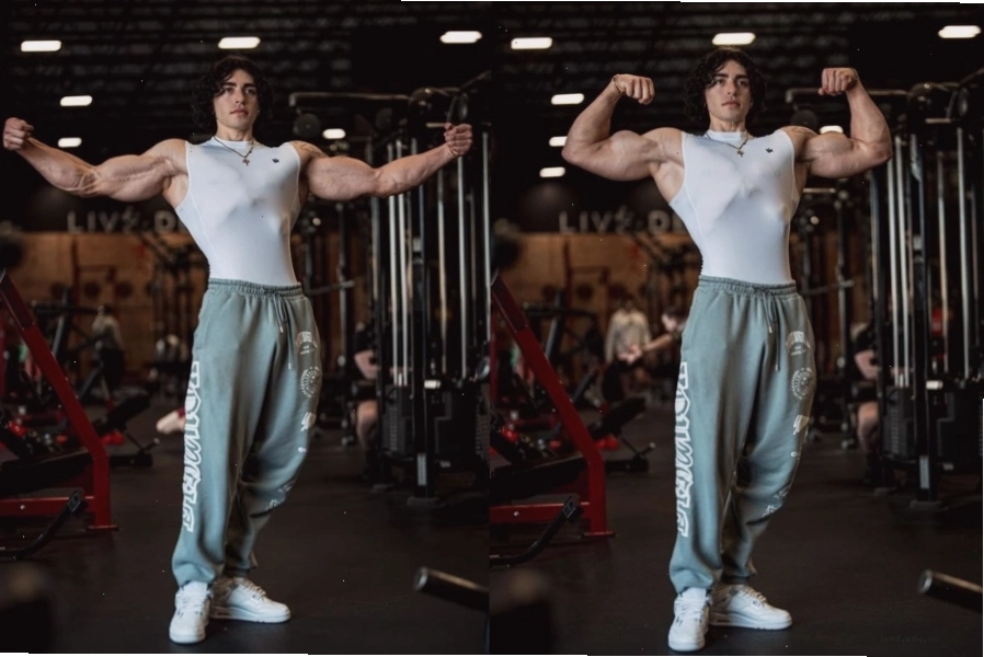 Đứng tạo dáng khoe cơ bắp tay nam tính trong phòng gym