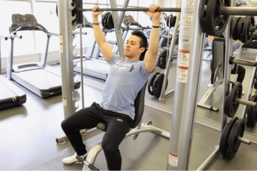 Người tập thực hiện động tác kéo cáp thẳng lên cao (Cable Upright Row)