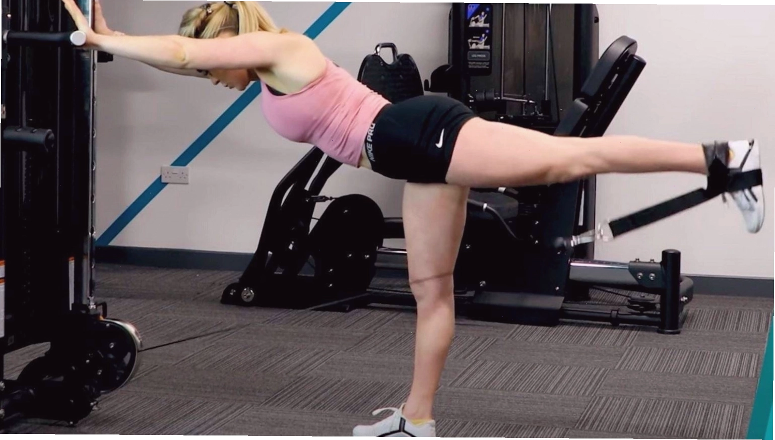 PT demonstrating how to do cable kickbacks
